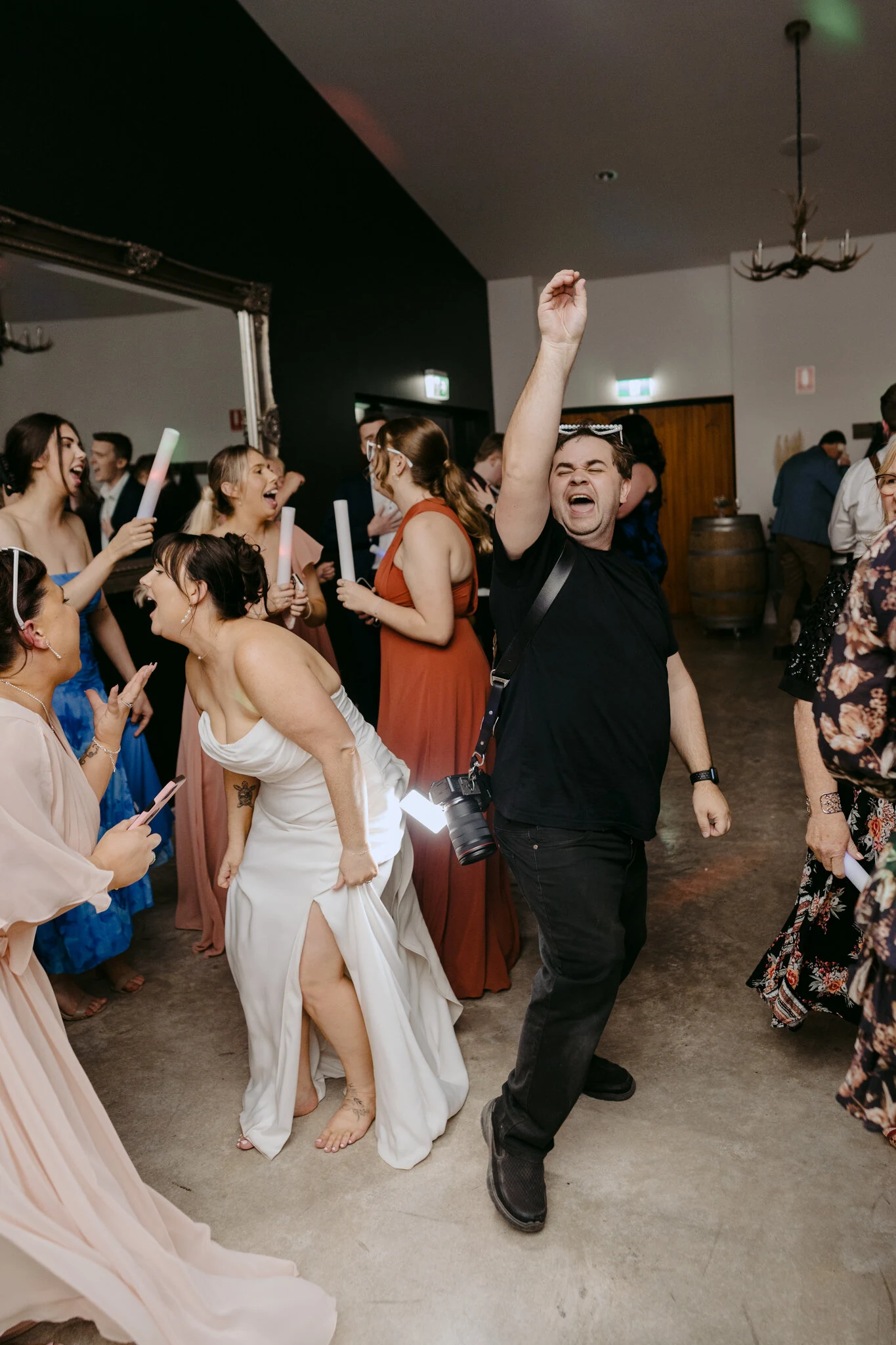 A couple and their wedding guests celebrating on the dance floor